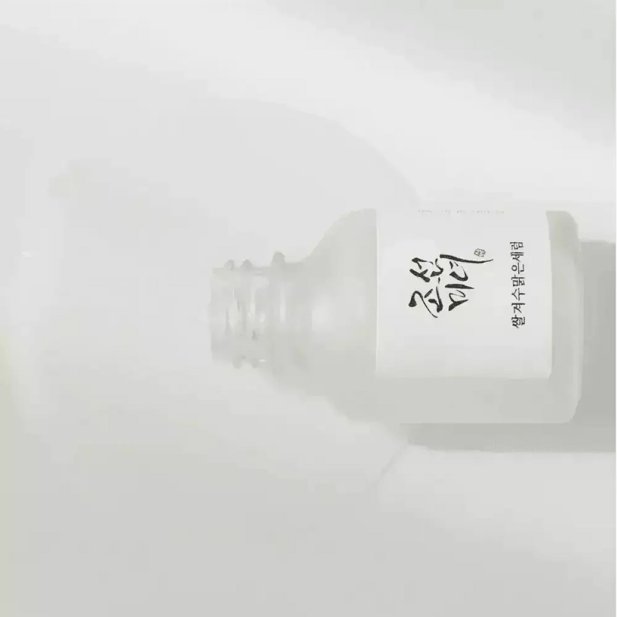 Flacon ouvert du sérum Beauty of Joseon Glow Deep couché sur fond blanc