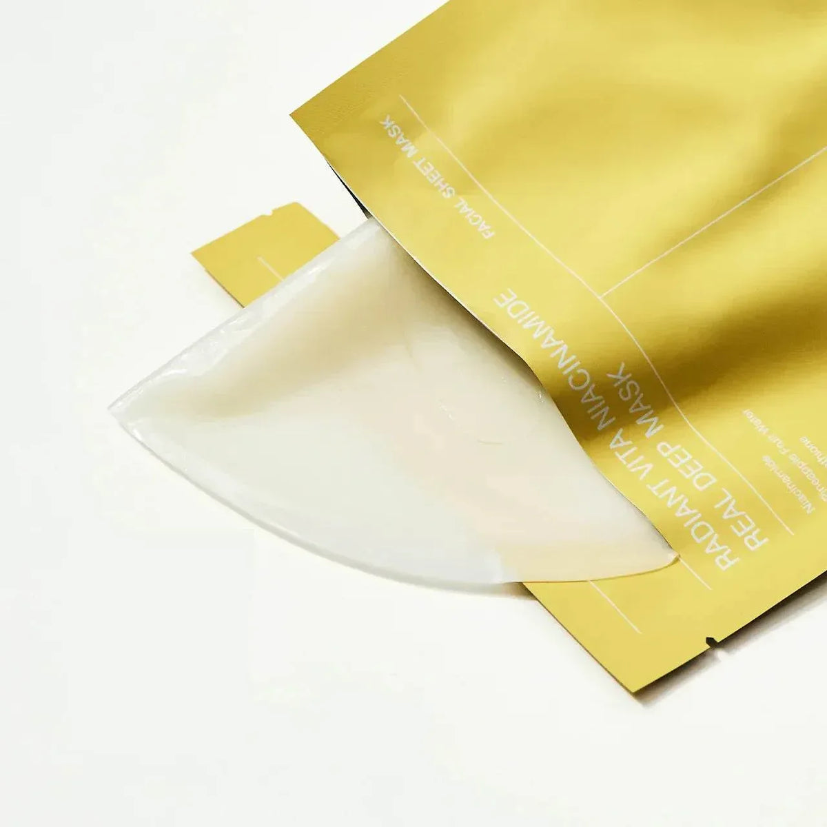 Feuille de masque hydrogel Biodance Radiant Vita Niacinamide sortant de son sachet jaune